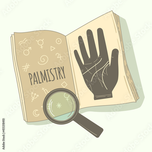 Palmistry. Textbook on palmistry and a magnifying glass.