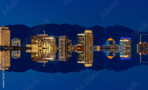 Mirror of Salt Lake City skyline at night with street lights on