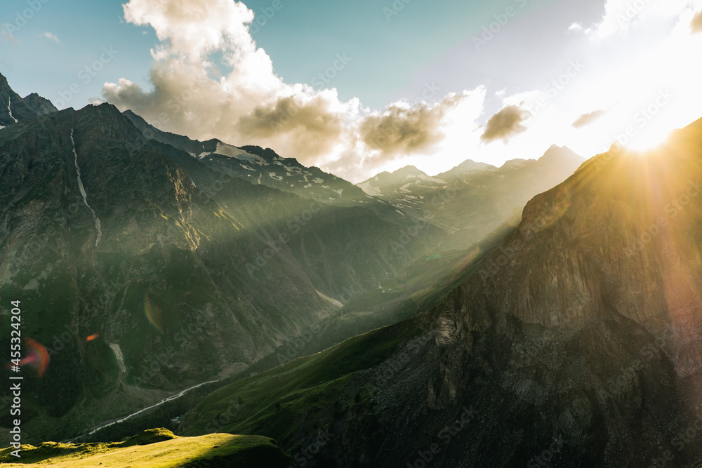 Beautiful mountain landscape on a summer evening, the sun's rays illuminate the mountain green valley and rocky slopes before sunset - obrazy, fototapety, plakaty 