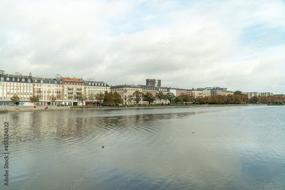Copenhagen, Denmark. September 27, 2019: Landscape on the city canals with a view of buildings and houses. Copenhagen, Denmark. September 27, 2019: Landscape on the city canals with a view of buildings and houses.