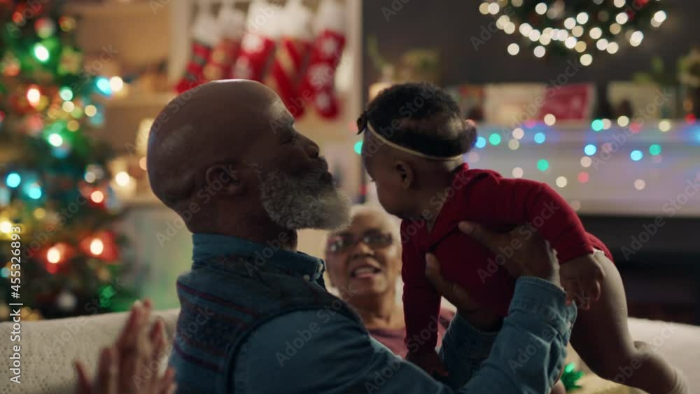 african american family christmas grandfather holding baby girl giving kiss proud of granddaughter happy grandparents enjoying festive holiday reunion at home 4k african american family christmas grandfather holding baby girl giving kiss proud of granddaughter happy grandparents enjoying festive holiday reunion at home 4k