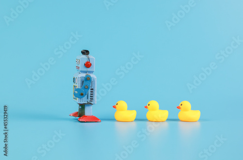 Obraz na plátně vintage retro robot and Yellow Rubber Bath Ducks, leadership concept