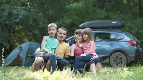 Wallpaper Mural Parents and their kids resting together and talking happily. Happy young family spending time at capmsite outdoors. Torontodigital.ca