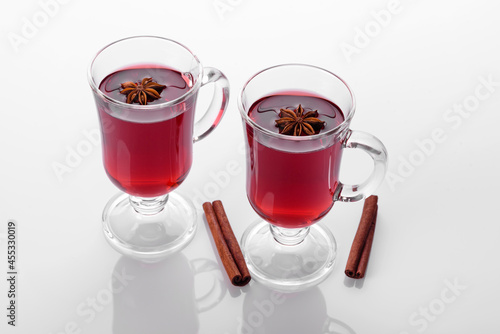 Hot red mulled wine isolated on white background with christmas spices