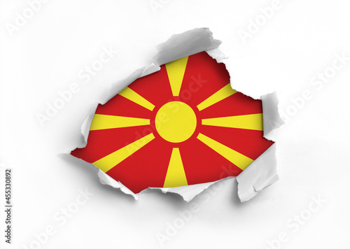 Flag of North Macedonia underneath the ripped paper