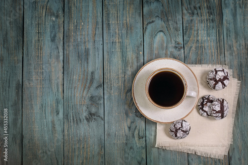 Cup of coffee with cookies on a wooden table, top view, background, copy space, breakfast.