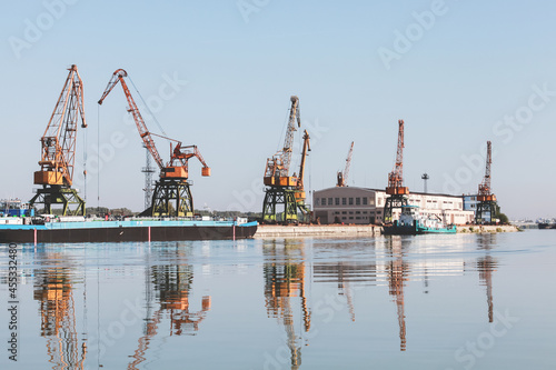 Port cranes stand at the pier in Ruse port, Danube river