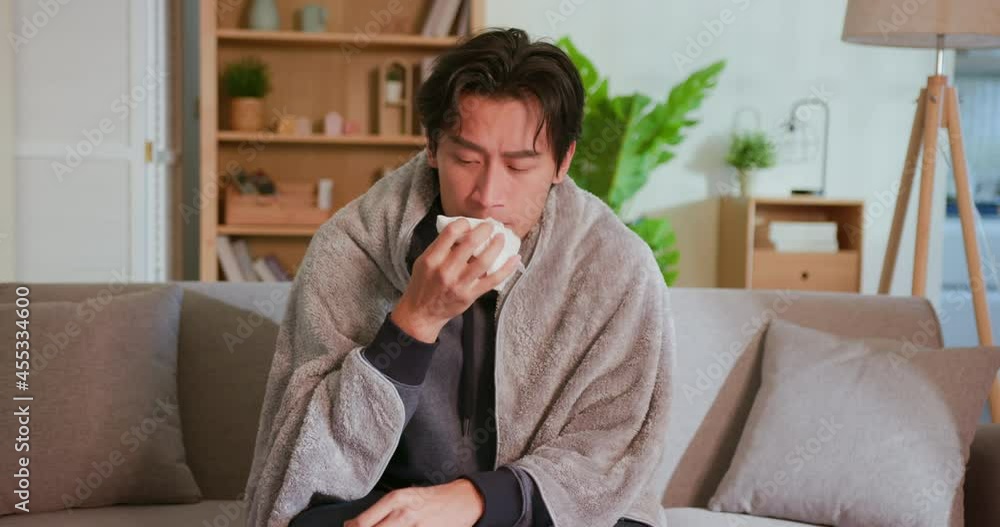 man coughs at home