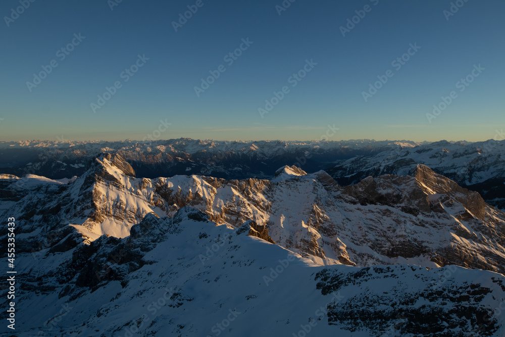 Amazing sunset at the top of one of the most impressive mountain in Switzerland called Säntis. Epic view over several cantons in Switzerland. Flying birds in front of the lens.