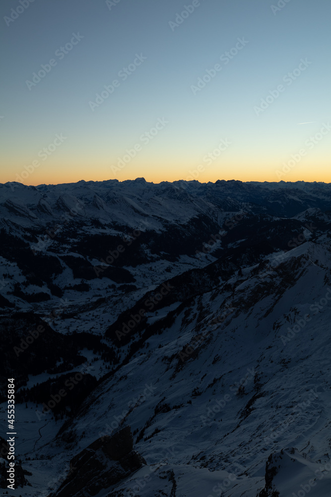 Amazing sunset at the top of one of the most impressive mountain in Switzerland called Säntis. Epic view over several cantons in Switzerland. Flying birds in front of the lens.