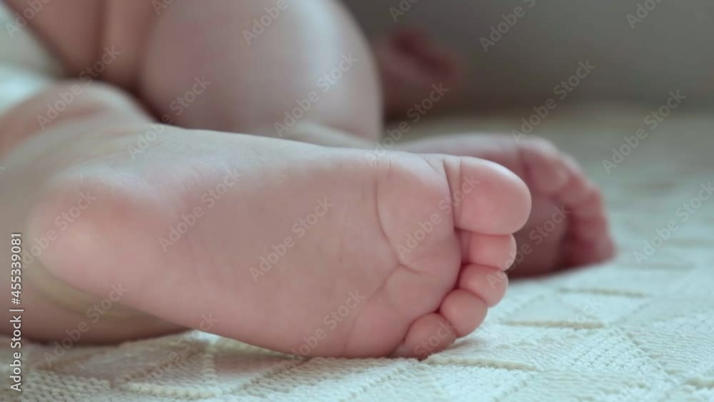 Tiny Babies Feet on White Blanket. Close up of Small Bare Feet of Baby Infant Sleeping on Soft Bed. Cute Newborn Baby Against Knitted Blanket. Concept of Childhood, Maternity. Sleeping Newborn Child. Tiny Babies Feet on White Blanket. Close up of Small Bare Feet of Baby Infant Sleeping on Soft Bed. Cute Newborn Baby Against Knitted Blanket. Concept of Childhood, Maternity. Sleeping Newborn Child.