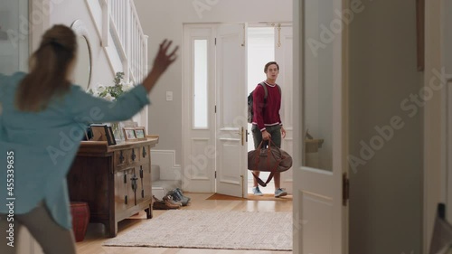 teenage boy arriving home from trip surprising family hugging mother and sister feeling excited enjoying surprise visit at home 4k