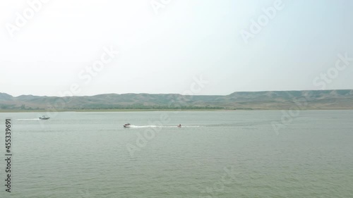 Jetski And Motorboats Cruising Across Lake Diefenbaker At Saskatchewan Landing Provincial Park In Canada. - Wide Shot photo