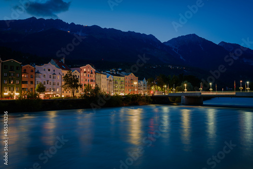 Colored houses on the Inn river with the mountains in the background at night, Tyrol, Innsbruck, Austria © JMDuran Photography