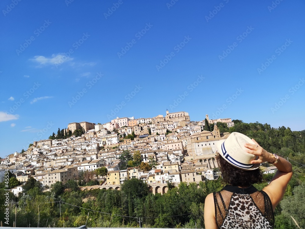 tourist admires the village of Loreto Aprutino, Abruzzo, Italy