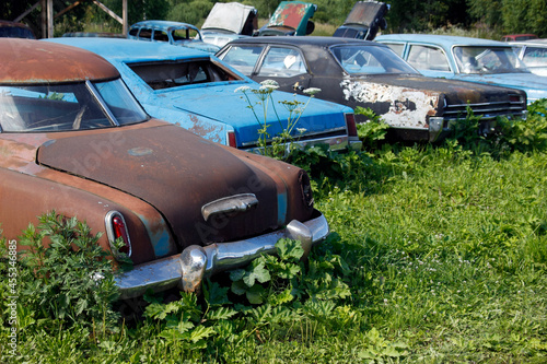 Old abandoned rusty vehicles, crushed cars in junkyard. Cars recycling concept.