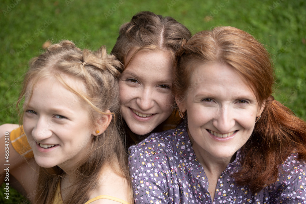 smiling mom and daughters smiling mom and daughters