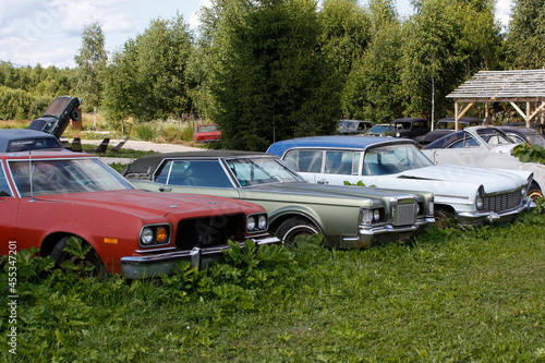 Old abandoned rusty vehicles, crushed cars in junkyard. Cars recycling concept.