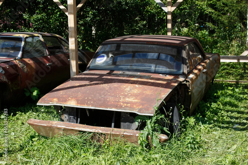Old abandoned rusty vehicles, crushed cars in junkyard. Cars recycling concept.
