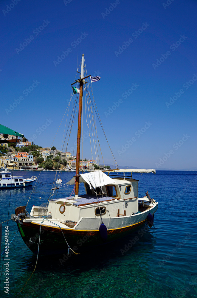 small boat in the harbor of symi