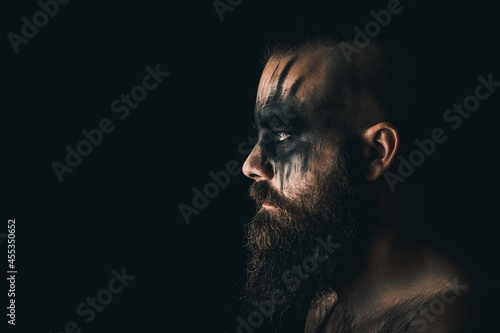 Portrait of a viking warrior with black war paint