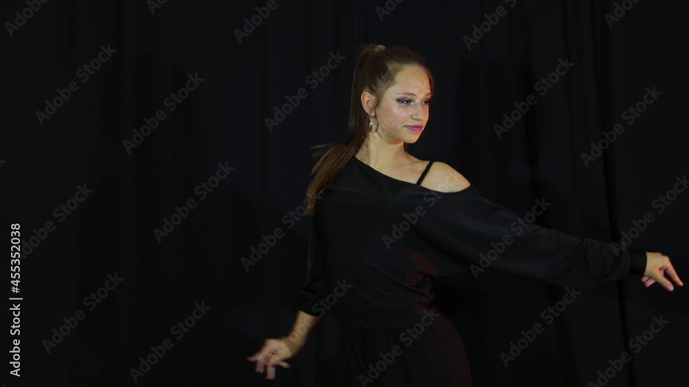Girl in black cloth actively dance latine Girl in black cloth actively dance latine
