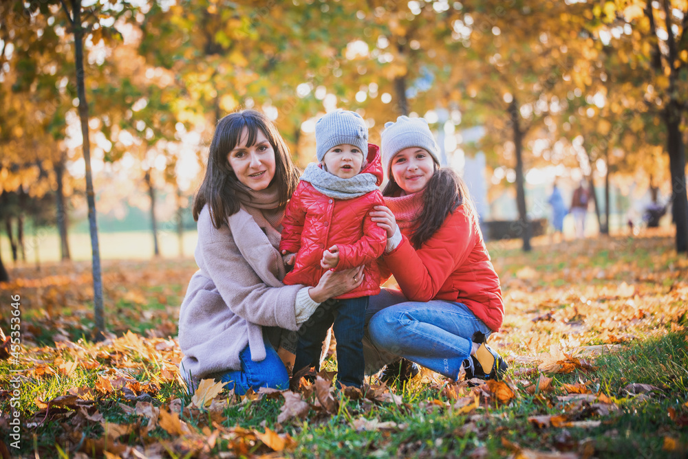 Mother and her child girl playing together on autumn walk in nature outdoors.Active games of happy family, lifestyle in autumn yellow park.movement, defocus, selective focus