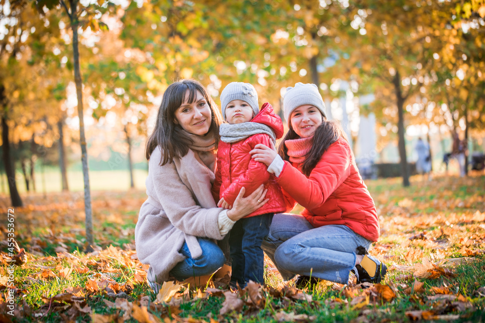 Mother and her child girl playing together on autumn walk in nature outdoors.Active games of happy family, lifestyle in autumn yellow park.movement, defocus, selective focus Mother and her child girl playing together on autumn walk in nature outdoors.Active games of happy family, lifestyle in autumn yellow park.movement, defocus, selective focus