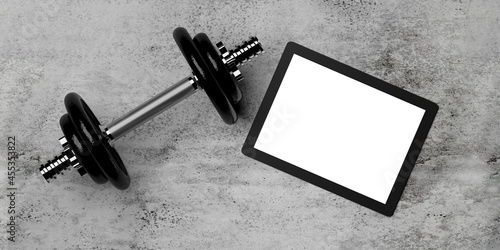 Dumbbell with weights and tablet computer on concrete floor flat lay top view from above with copy space, online fitness video or application template photo