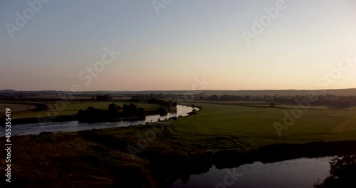Aerial view of an extensive river landscape in colorful dusk