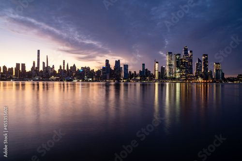 New York  NY - USA - Horizontal image of the skyline of the westside of Manhattan at sunrise  with reflections seen in the Hudson River.