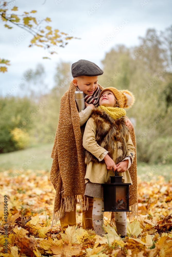 Happy Family in Autumn Park. boy and girl hugging.