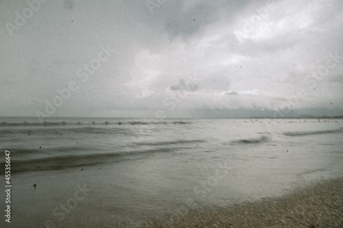 Fototapeta Naklejka Na Ścianę i Meble -  seascape covered with cloudy gray clouds, vintage photo