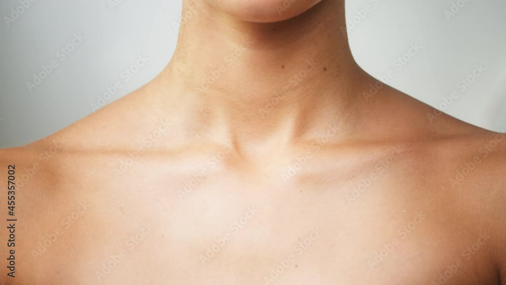 Young woman clavicles close-up, model with smooth healthy skin. Female shoulders, naked body. Beauty and body care concept. Unrecognizable person with bare neck and chest on white background. Young woman clavicles close-up, model with smooth healthy skin. Female shoulders, naked body. Beauty and body care concept. Unrecognizable person with bare neck and chest on white background.