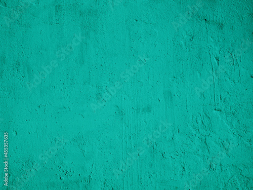 Abstract background from bright green plaster on the wall.
