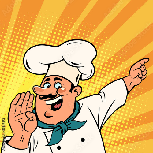 Man chef in a white cap. Smiling face. Professional points a finger