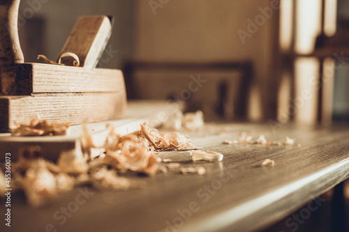 Plane jointer carpenter or joiner tool and wood shavings. Woodworking tools on wooden table