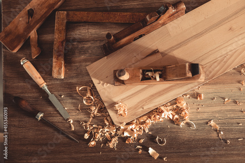 Plane jointer carpenter or joiner tool and wood shavings. Woodworking tools on wooden table