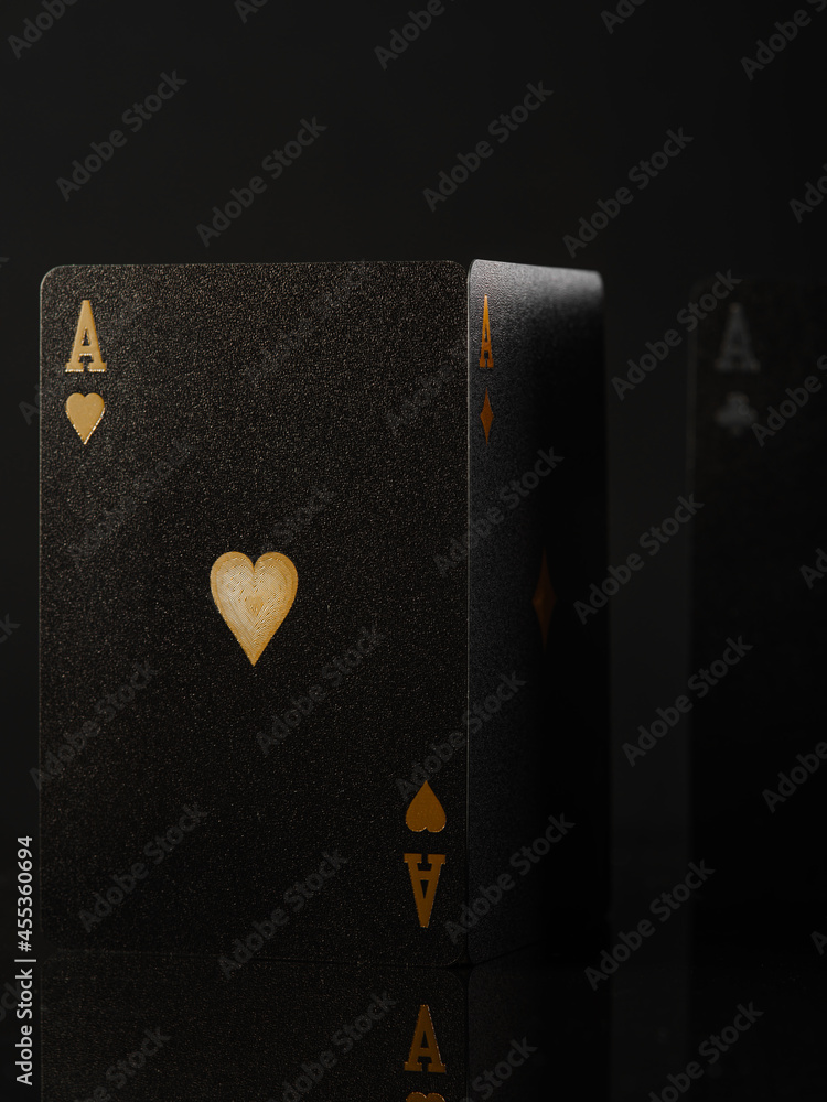 Obraz premium Casino. Gambling. Poker cards. Ace of hearts. Black background. Minimalism. Risk, chance of luck. Poker club, strategy games, gambling and advertising business.