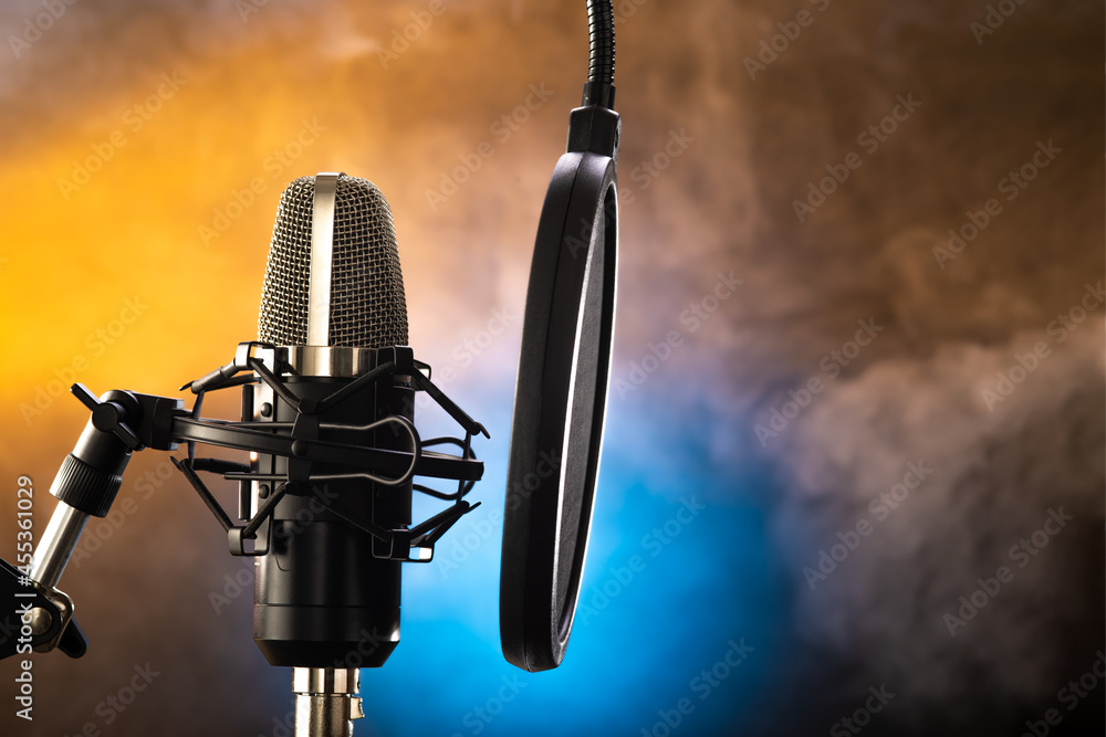 Professional studio microphone on a blue background, smoke. Nightlife,  concert, vocals, singing, nightclub, recording studio, bohemia. Minimalism.  There are no people in the photo. Stock Photo | Adobe Stock