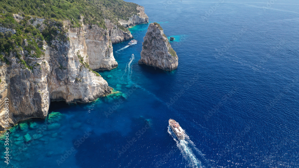 Aerial drone photo of iconic Ortholithos and azure caves with deep turquoise sea where submarine Papanikolis was hiding during world war II, Paxos island, Ionian, Greece
