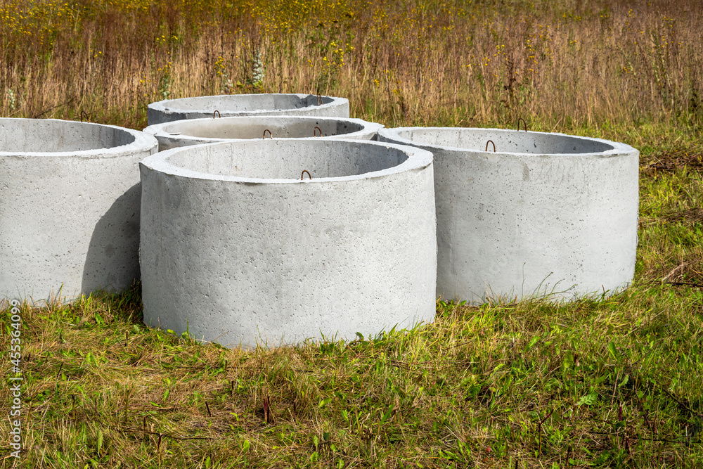Prefabricated concrete sewer situated  on a green meadow.
