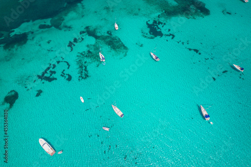 Aerial view of many yachts and sailboats in turquoise water in Mediterranean Sea