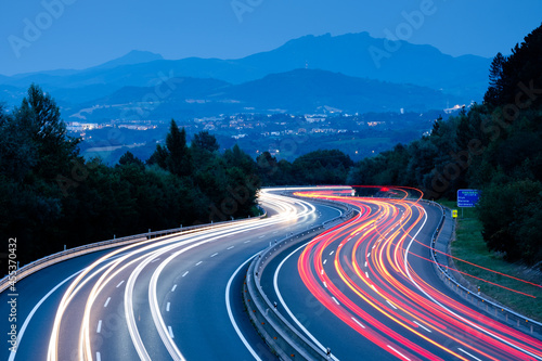 Car lights at sunset driving at high speed on the highway, San Sebastian, Euskadi