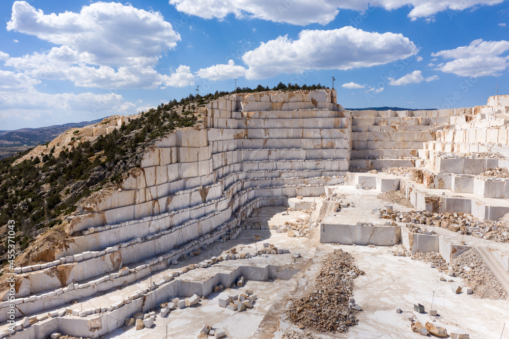 Marble quarry and cut marble blocks, background cloudy blue sky. Karamanli, Burdur TURKEY