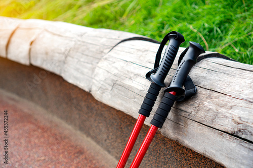 A pair of red walking sticks for scandinavian nordic walking. photo