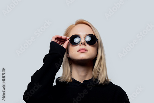 Wallpaper Mural blonde in black and round sunglasses on a white background Torontodigital.ca
