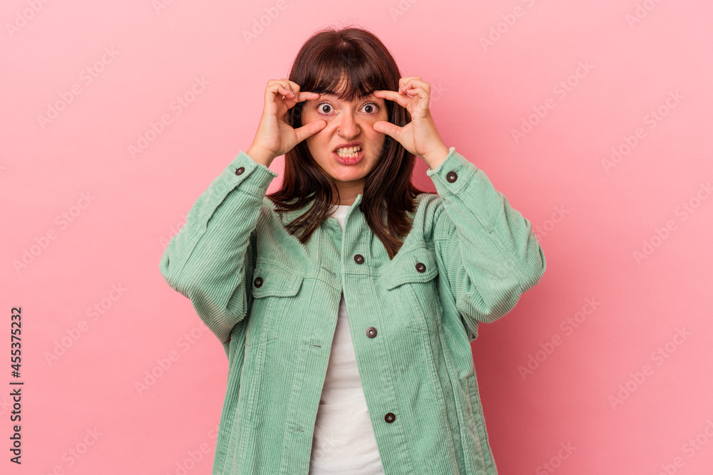 Young curvy caucasian woman isolated on pink background keeping eyes opened to find a success opportunity. Young curvy caucasian woman isolated on pink background keeping eyes opened to find a success opportunity.