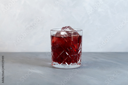 Glass of Americano Alcohol cocktail with red vermouth, bitter, soda water and ice cubes