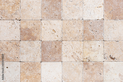 Natur stone wall from small square parts. Background or texture for interior.